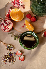 Fruit and berry tea in a bowl on a beige background 