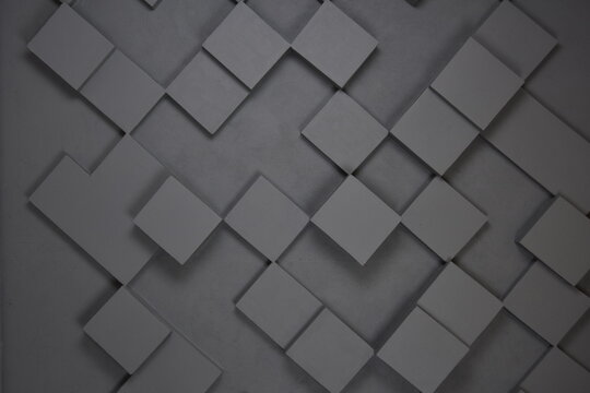 wall of grey geometry tiles - freshly painted wall, gray scale design background - shallow depth of field horizontal photo