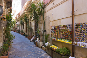 Fototapeta na wymiar Narrow and picturesque street on Ortigia Island in Siracusa, Sicily, Italy 