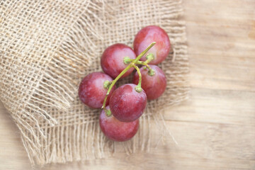 Red grapes placed on background, View from above