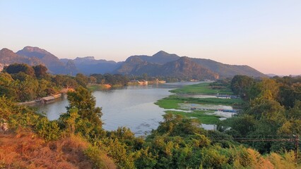 The beautiful scenic Kwai Noi river or Saiyok river in Kanchanaburi Province of Thailand in the evening.