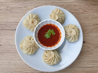 Pork momo, served pan fried eat with chilli paste sauce, Bhutan food.