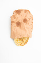 bread in a paper packet over on white background