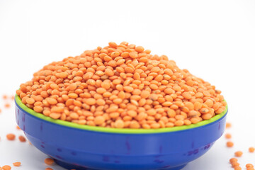Red lentils pile isolated on white background, also known as raw daal, dhal, masoor dhal