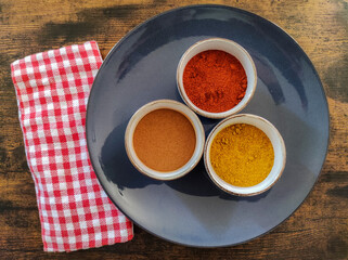 spices isolated in bowls on a tray