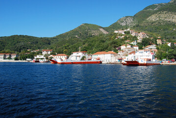 Fototapeta na wymiar The ferry transports tourists and cars across the Bay of Kotor. Montenegro