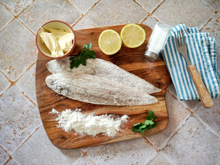 raw fish with flour on a wooden board