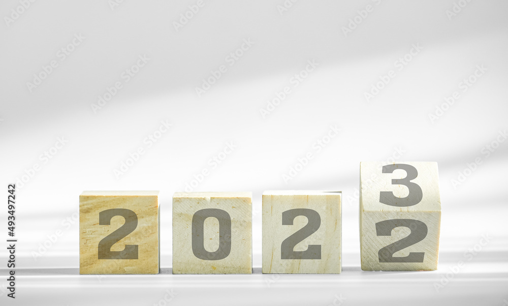 Poster concept of new year, change number on wood block from 2022 to 2023