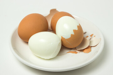 Boiled eggs on a white background. Shelled egg. Cooking chicken eggs