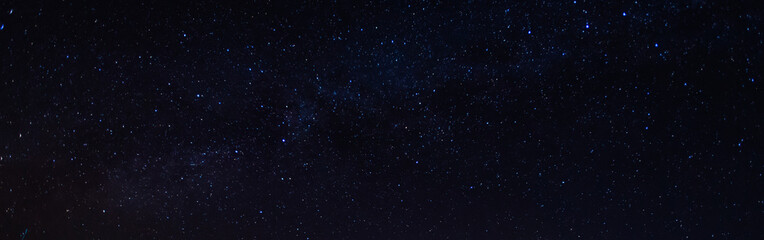 Panorama, blue night sky, milky way and stars on a dark background, universe filled with stars,...