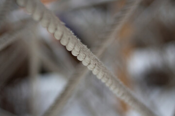 Tangled ropes. Crossing ropes. Texture of thread in snow. Labyrinth of ropes.