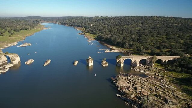 Aerial view of the border river Guadiana Between Elvas Portugal And Olivenza Spain and historic Ajuda Bridge. Destroyed abandoned Ajuda bridge drone aerial view