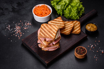 Fototapeta na wymiar Delicious fresh toast grill with cheese and ham. Sandwiches, quick snack
