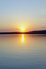 Fototapeta na wymiar Warm orange sunset sky over Montargil lake, Portalegre, Portugal