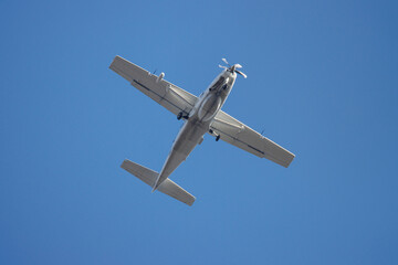  close up of a propeller plane in the blue sky