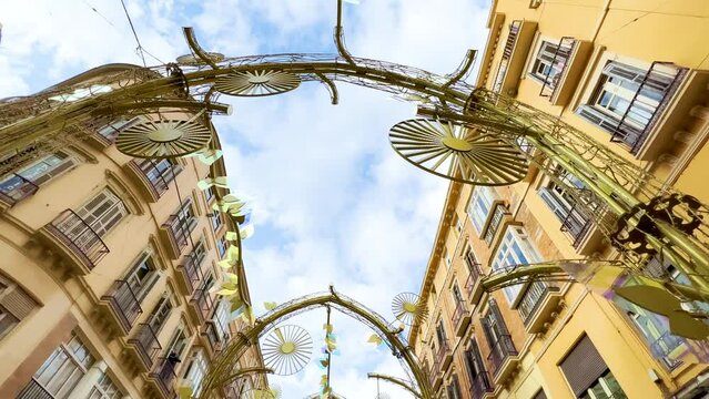 Larios Street centre of Malaga. City day light main walking street in Malaga Spain. Beautiful street iron decoration in old center city