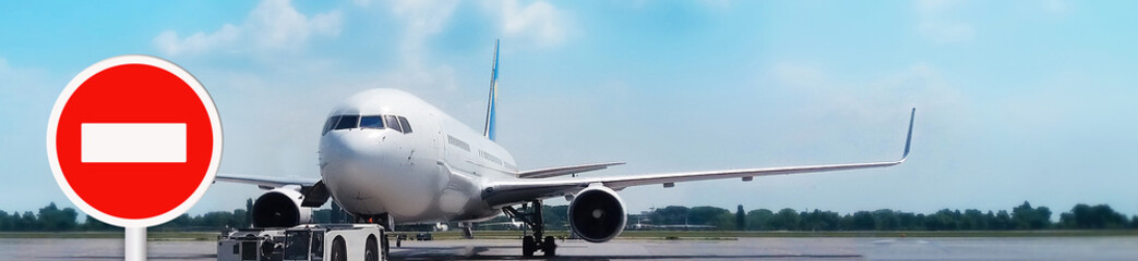 No fly zone sign on the background of the plane at the airport.The ban on flights of aircraft in...
