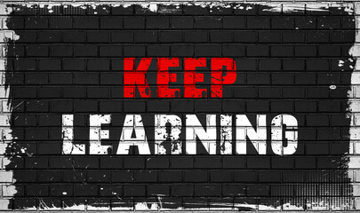 keep learning, concept on black wall 