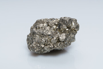 Raw crystalline pyrite (iron pyrite, fool's gold). Mineral pyrite from the group of sulfides. The mineral pyrite on a white background
