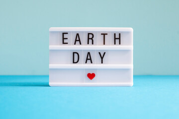 World environment day concept. The inscription on the light box on a blue background. 