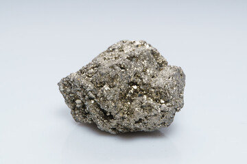 Raw crystalline pyrite (iron pyrite, fool's gold). Mineral pyrite from the group of sulfides. The mineral pyrite on a white background