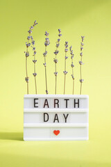 Concept of the Environment World Earth Day. The inscription on the light box on a green background. Environmental protection for the new generation. 