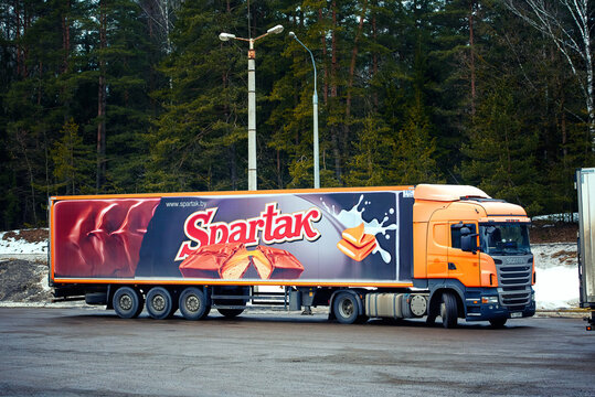 Minsk, Belarus. Feb 2022. Scania R420 company truck of Confectionery factory "Spartak" - largest manufacturer of confectionery products in Belarus. Chocolate candy with nougat on the truck side
