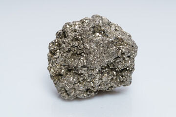 Raw crystalline pyrite (iron pyrite, fool's gold). Mineral pyrite from the group of sulfides. The mineral pyrite on a white background