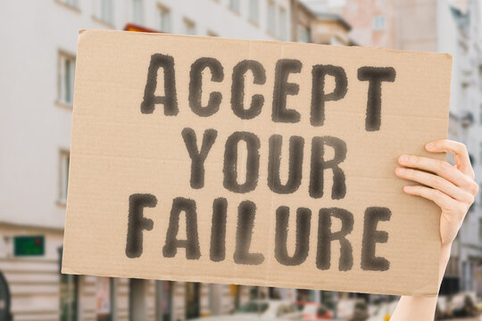 The phrase " Accept your failure " on a banner in men's hands with blurred background. Strategy. Fail. Lose. Succeed. Bankrupt. Crash. Drop. Waste. Fall. Collapse. Acceptance. Bankruptcy. Confused