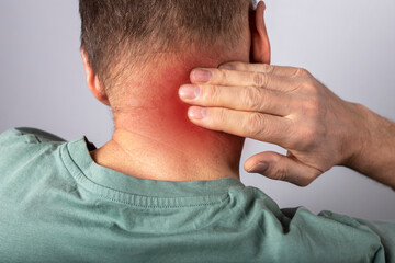 Obraz premium Man suffering from neck pain. Head back with red point closeup. Health problems and medicine concept. High quality photo
