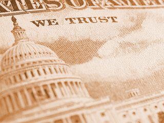 American paper money background. Fragment of reverse of $50 bill showing the Capitol. US banknote closeup. Light brown tinted wallpaper. Public national debt and USA dollar. Bonds and treasurys. Macro