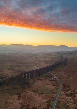Aerial drone photograph of Ribblehead Viaduct at sunrise. Yorkshire Dales, UK.