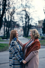 Fototapeta premium A grandmother bonding with her granddaughter while standing and holding hands.