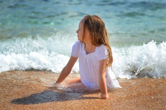 Photo can be for backgrounds and blanks little girl on the sea. High quality photo