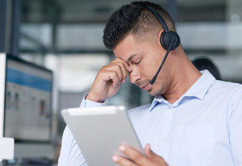 I just cant seem to solve this one. Shot of a young call centre agent looking stressed out while...