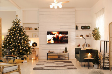 Plasma TV on white wooden wall in living room beautifully decorated for Christmas