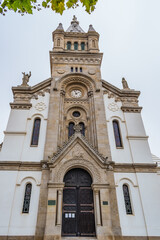 Fototapeta na wymiar Facade with imposing symmetrical tower of the Church of Our Lady of Help, Espinho PORTUGAL