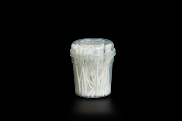 Canister, box of unmarked white swabs on black background.