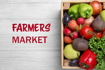 Crate of fresh vegetables on white wooden table, top view. Farmers market