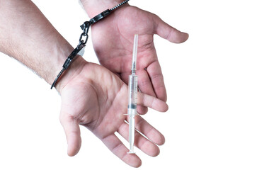Man hands with handcuffs holding the syringe.