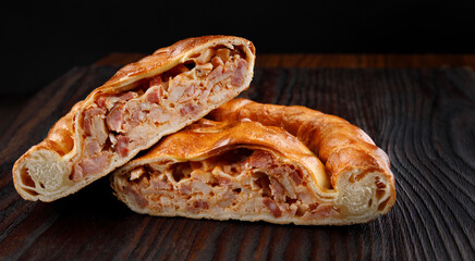 Two pieces of homemade pie on a wooden surface.