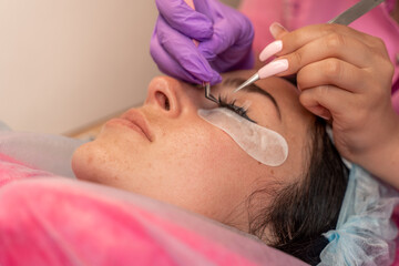 Naklejka premium Eyelash extension procedure. Woman eye with long eyelashes. lashes, close up, macro, selective focus.