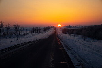 Winter road at sunrise, roads of Kazakhstan.