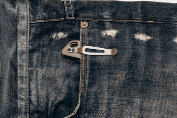 Male Knife in Jeans Pocket, other every day carry (EDC) items. - obrazy, fototapety, plakaty