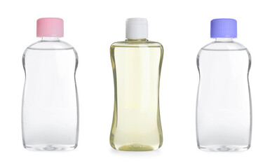 Set with bottles of baby oil on white background