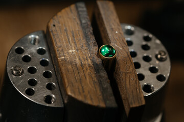 Craft jewelery making with professional tools. Ring repairing. Putting the diamond on the ring. Macro shot. A handmade jeweler process, manufacture of jewelery.