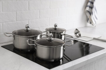 Set of new clean cookware on cooktop in kitchen