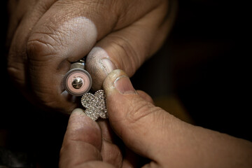 Different goldsmiths tools on the jewelry workplace. Jeweler at work in jewelry. Desktop for craft...