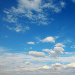 White clouds against bright azure sky.