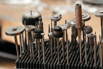 Front view of a set of various tools placed on a wooden desk in a workshop